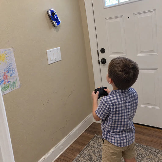 Kid driving the wall climbing car in a hallway